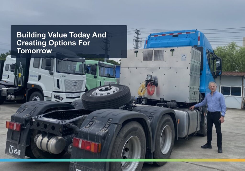 Sunshine CEO Rick McElhinney beside a Farizon electric truck with a methanol range extender at Farizon's factory in China
